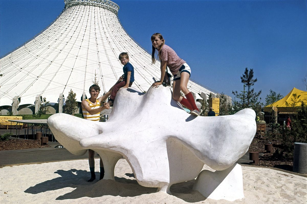 Kids climb the bone sculpture at Expo 