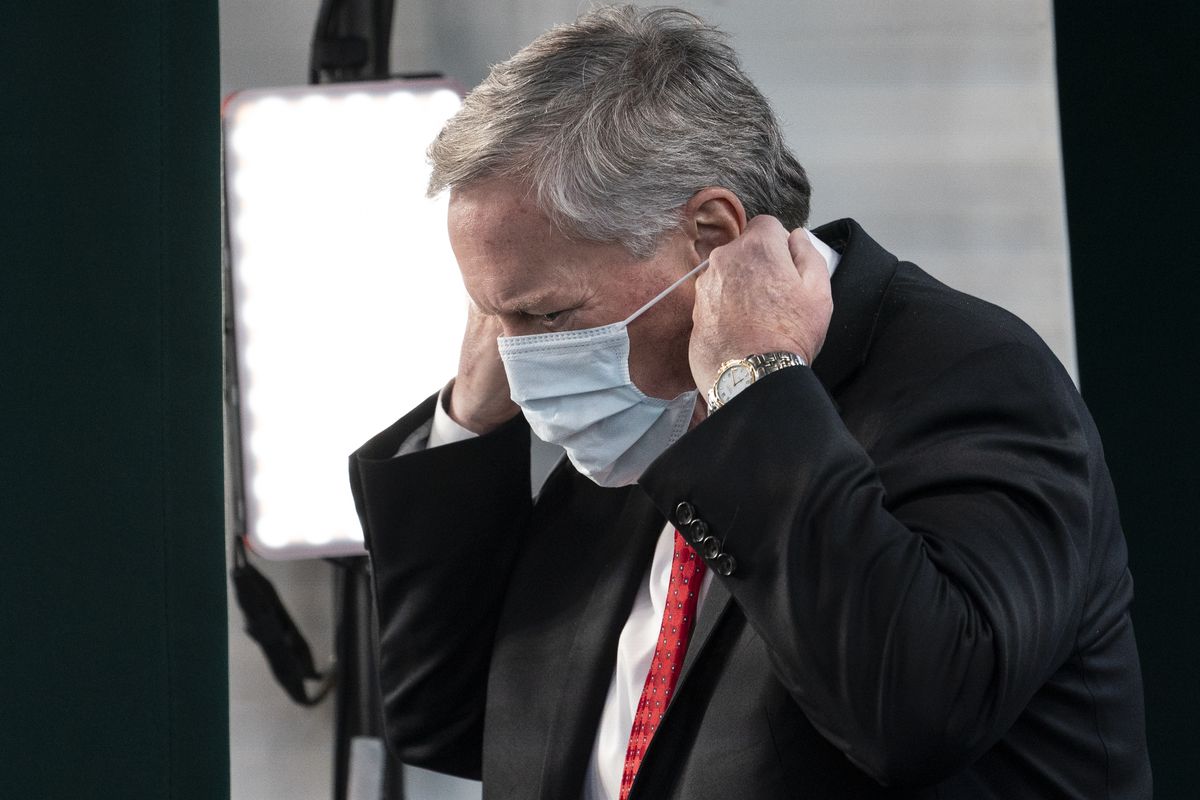 White House chief of staff Mark Meadows replaces his face covering after a television interview at the White House, Wednesday, Oct. 7, 2020, in Washington.  (Alex Brandon)
