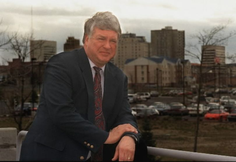 Terry Novak, former Spokane city manager, stands on the patio of the SIRTI building in August 1997 with the downtown skyline behind him. He died Aug. 15 at his Spokane home at the age of 68. (Christopher Anderson / The Spokesman-Review)