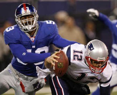 
Giants LB Reggie Torbor pressures Patriots QB Tom Brady in their regular-season matchup. Associated Press
 (Associated Press / The Spokesman-Review)