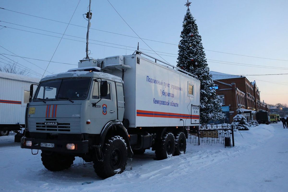 A Russian Emergency Ministry truck is parked at the Listvyazhnaya mine, right, near Belovo, in the Kemerovo region of southwestern Siberia, Russia, Friday, Nov. 26, 2021. A devastating explosion in the Siberian coal mine Thursday left dozens of miners and rescuers dead about 250 meters (820 feet) underground, Russian officials said.  (Sergei Gavrilenko)