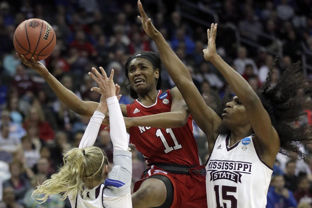North Carolina State guard Kiara Leslie (11) shoots between Mississippi State guard Blair Schaefer (1) and center Teaira McCowan (15) during the first half of a women