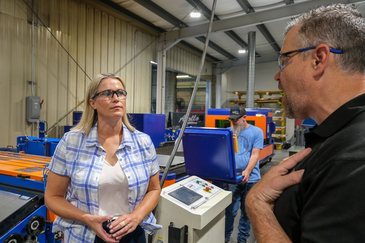 Tiffany Smiley, a Republican running for Washington’s 4th congressional district, listens to Ryan Ratchford, president of Apollo Mechanical Contractors, while touring the company’s factory in Kennewick on Aug. 2, 2024.  (Orion Donovan Smith/The Spokesman-Review)