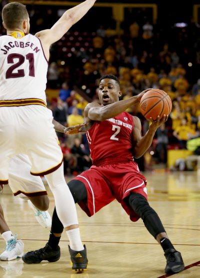 Washington State guard Ike Iroegbu looks to pass around Arizona State forward Eric Jacobsen during the first half of a Pac-12 game last week. (Matt York / Associated Press)