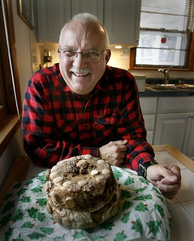 Pierre Girard displays the fruitcake, circa 1911, the centerpiece at most of his holiday gatherings. McClatchy-Tribune (McClatchy-Tribune / The Spokesman-Review)