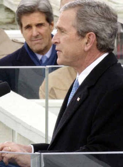 
Sen. John Kerry, D-Mass., looks on as President Bush delivers his inaugural speech  Thursday. 
 (Associated Press / The Spokesman-Review)