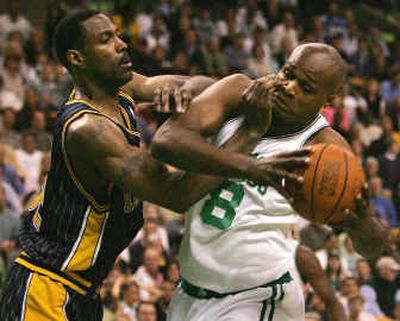 
Pacers forward Dale Davis, left, throws his hands in the face of Celtics forward Antoine Walker on a drive to the basket.
 (Associated Press / The Spokesman-Review)