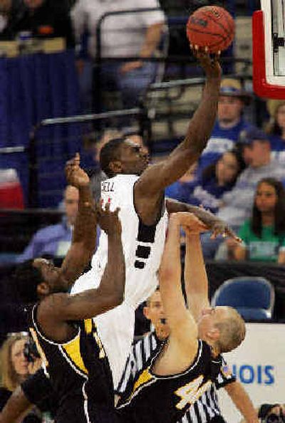 
Cincinnati's Jason Maxiell, center, goes up for a shot. 
 (Associated Press / The Spokesman-Review)