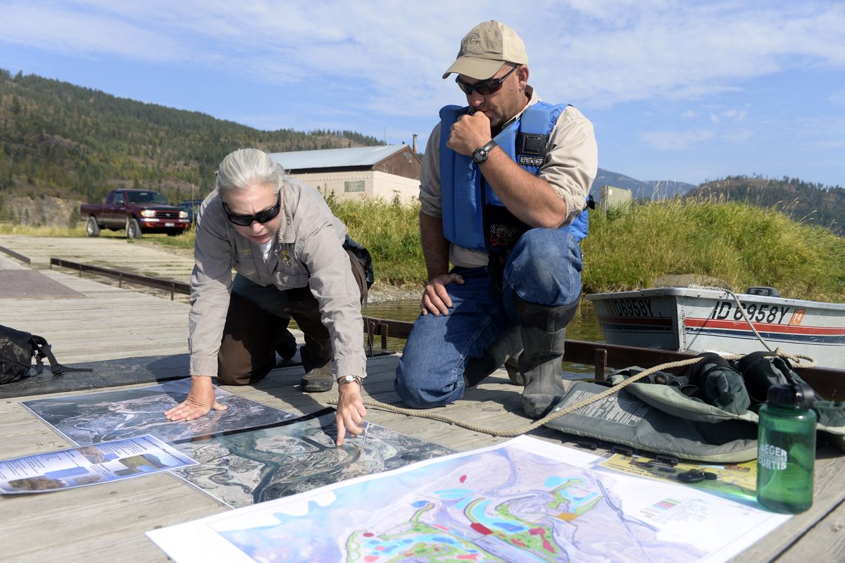 Katherine Cousins of the Idaho Department of Fish and Game and Brian Heck, an engineer for Ducks Unlimited, look at historical and contemporary aerial photos of the delta before touring the area on Sept. 22.
