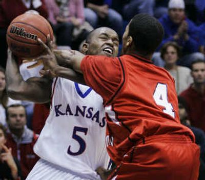 
Eastern's Gary Gibson, right, fouls Rodrick Stewart of Kansas. Associated Press
 (Associated Press / The Spokesman-Review)