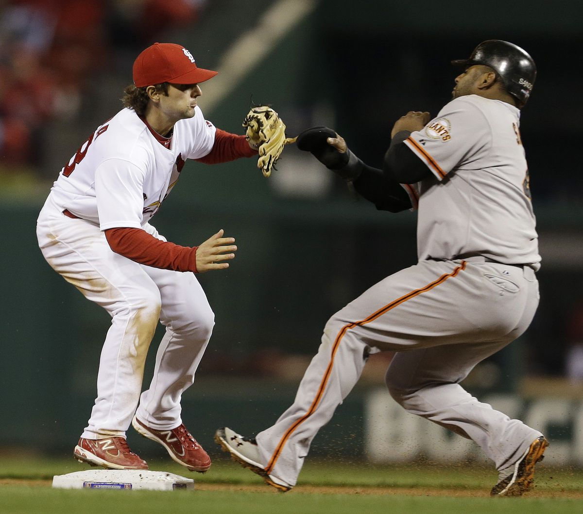 Pablo Sandoval is safe at second when St. Louis shortstop Pete Kozma can't handle a throw in fourth inning. (Associated Press)
