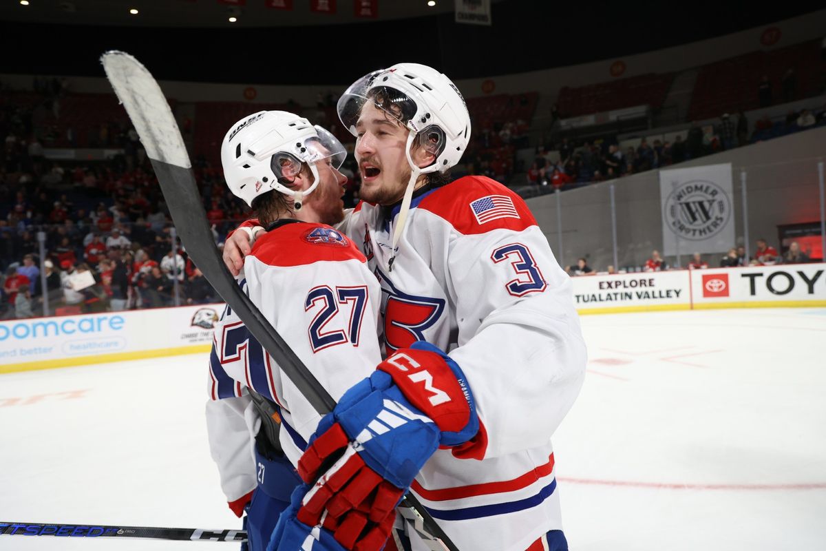 Spokane Chiefs captain Berkly Catton, left, and defenseman Brayden Crampton celebrate sweeping the Portland Winterhawks in the WHL Western Conference championship on Friday at Portland’s Veterans Memorial Stadium. (Jaime Valdez/The Spokesman-Review)