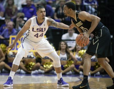 In this Feb. 20, 2018, file photo, LSU forward Wayde Sims (44) defends against Vanderbilt forward Jeff Roberson (11) during an NCAA college basketball game, in Baton Rouge, La. LSU basketball player Wayde Sims has died after he was shot near the campus of another school in Baton Rouge. Police say in a news release that the 20-year-old Sims was shot around 12:30 a.m. Friday, Sept. 28, 2018, near the campus of Southern University. Sgt. Don Coppola Jr. said Sims was taken to a hospital with an apparent gunshot wound and died. (Hilary Scheinuk / Advocate via AP)