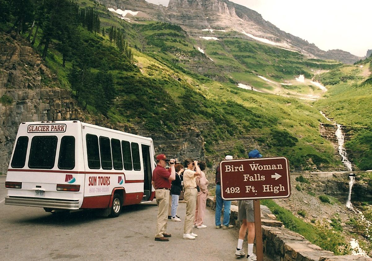 This image provided by Sun Tours shows visitors stopping on Going-to-the-Sun Road to view Bird Woman Falls in summer 2005, inside Glacier National Park in Montana.  (File Associated Press / The Spokesman-Review)