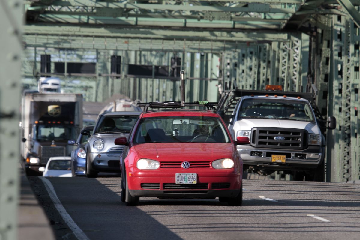 Early morning traffic crosses the Interstate 5 bridge spanning the Columbia River between Oregon and Washington states in Vancouver, Wash. (Associated Press)