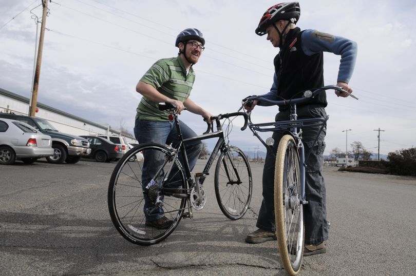 Brandon Englund, left, and Petey Creighton talk about their new bikes outside the headquarters of Mountain Gear, their employer, Tuesday.  A total of 22 people  bought bikes for commuting.jesset@spokesman.com (Jesse Tinsley)