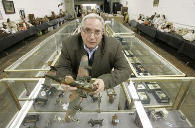 J. Louis Karp, owner of Main Auction Galleries Inc., holds a Marx camouflaged 1930s toy airplane inside his business in Cincinnati.  (Associated Press / The Spokesman-Review)