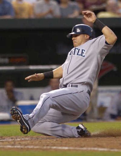 
Seattle's Jose Vidro slides home on a grounder hit by Richie Sexson. Vidro hit a home run and drove in four runs.Associated Press
 (Associated Press / The Spokesman-Review)