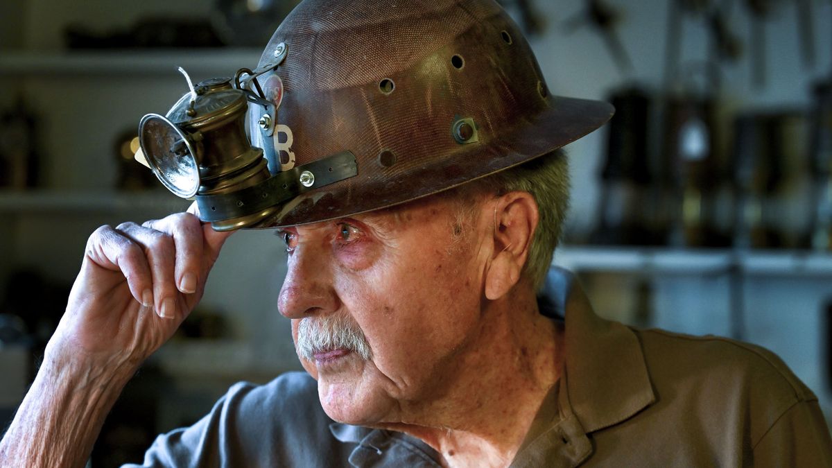 Retired geologist and mining engineer Bob Weldin talks about the 1940s helmet that is part of his collection of mining antiques at his home in Spokane on May 30.  (Kathy Plonka/The Spokesman-Review)