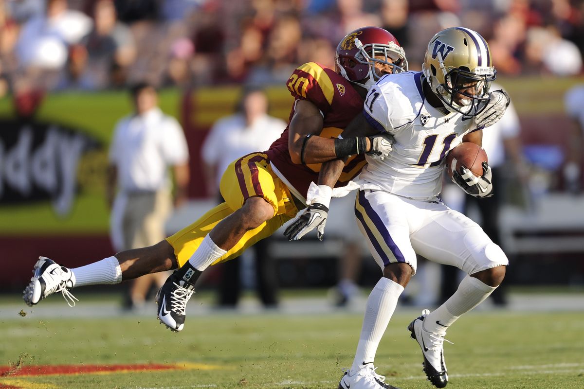  Washington’s D’Andre Goodwin (11) attempts to break a tackle after a first-half reception. (Associated Press)