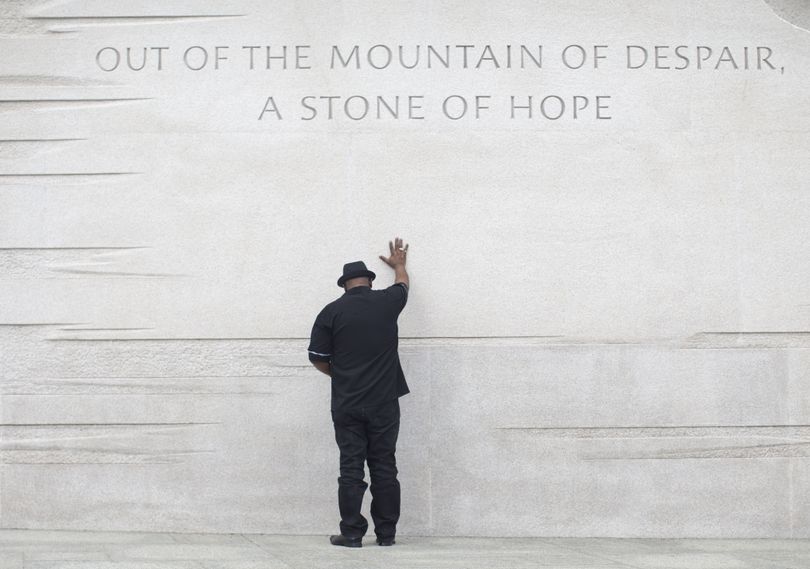 The Rev. Bobby Turner of Columbus, Ohio, places his hand on the Martin Luther King Jr. Memorial. President Barack Obama is scheduled to speak on the 50th anniversary of the 1963 March on Washington. (Associated Press)