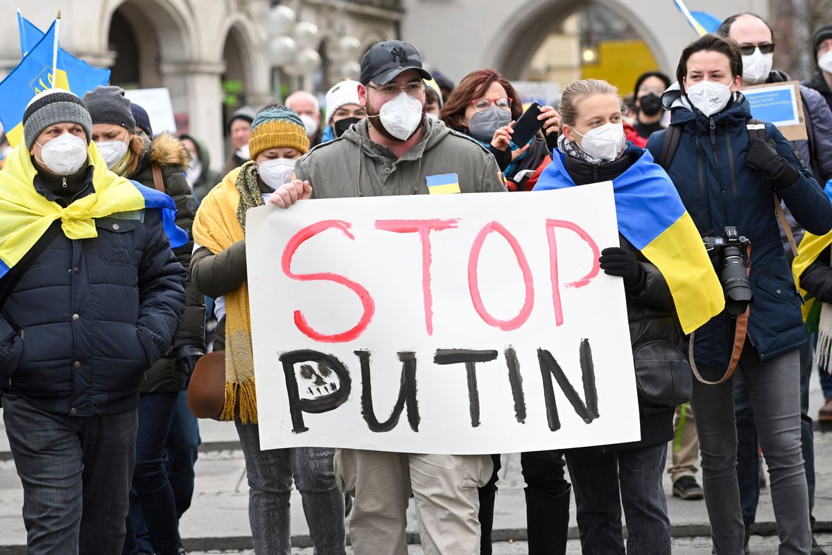 Protesters hold a placard reading "Stop Putin" during a demonstration at Odeonsplatz against Russia