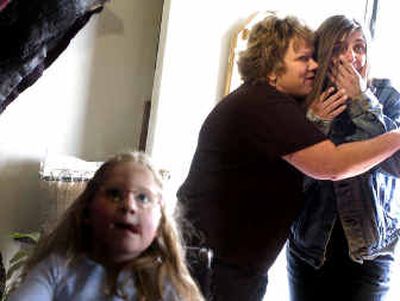 
Clinkerdagger's manager, Debi Moon, center, hugs homeowner Linda Forrester as she walks into the door of her completely remodeled North Side home on Wednesday. Moon originated the idea of the makeover to help Forrester and her daughter, both with disabilities, with a complete home makeover.
 (Photos by Jed Conklin/ / The Spokesman-Review)