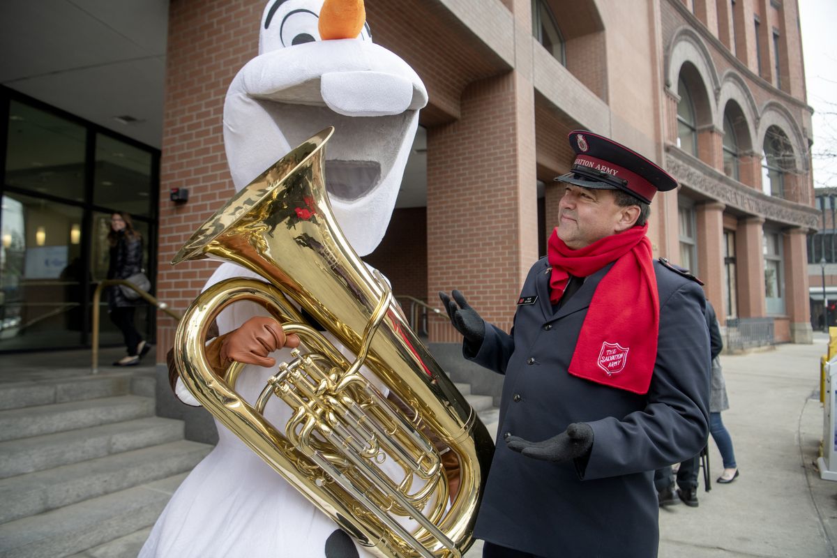 Spokesman-Review editor Rob Curley, left, dressed as Olaf from “Frozen,” clowns around with Salvation Army Major Ken Perine during bell-ringing on Nov. 15, 2018, in front of The Spokesman-Review building.  ( Jesse Tinsley/THE SPOKESMAN-REVIEW)