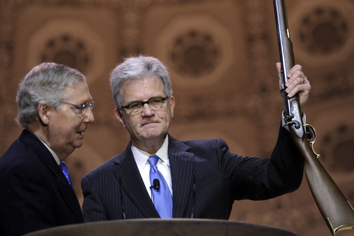 Senate Minority Leader Mitch McConnell of Ky., left, stands with Sen. Tom Coburn, R-Okla., after giving him a rifle, on stage at the Conservative Political Action Committee annual conference in National Harbor, Md., Thursday, March 6, 2014. Thursday marks the first day of the annual Conservative Political Action Conference, which brings together prospective presidential candidates, conservative opinion leaders and tea party activists from coast to coast. (Associated Press)