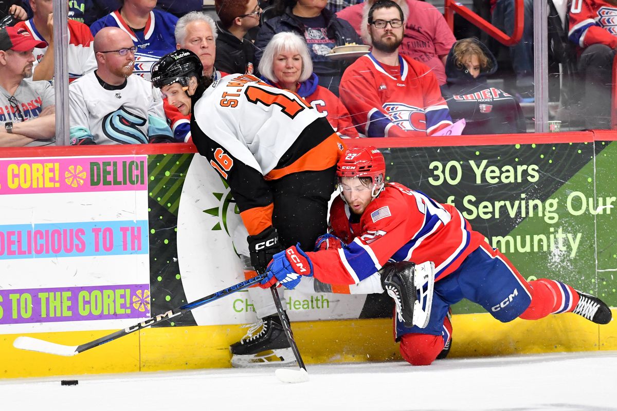 Spokane Chiefs center Berkly Catton (27) dives for a loose puck against Medicine Hat left wing Hunter St. Martin (16) during the second period in Game 4 of the Western Hockey League Championship on Wednesday, May. 14, 2025, at Spokane Arena in Spokane, Wash. (Tyler Tjomsland/The Spokesman-Review)