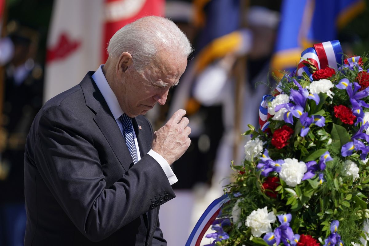 President Joe Biden makes the sign of the cross as he places a wreath at the Tomb of the Unknown Soldier at Arlington National Cemetery on Memorial Day, Monday, May 31, 2021, in Arlington, Va.  (Alex Brandon)