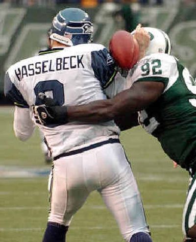 
Seattle quarterback Matt Hasselbeck suffered an elbow injury on this hit by Jets defensive end Shaun Ellis. 
 (Associated Press / The Spokesman-Review)