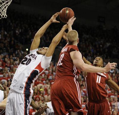 Gonzaga's Elias Harris battles for a rebound against WSU’s Brock Motum (12) and Faisal Aden (11). (Colin Mulvany)