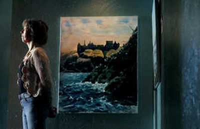 
Jan Clizer of Coeur d'Alene stands near one of her paintings on display at Cafe Doma. 
 (Kathy Plonka / The Spokesman-Review)