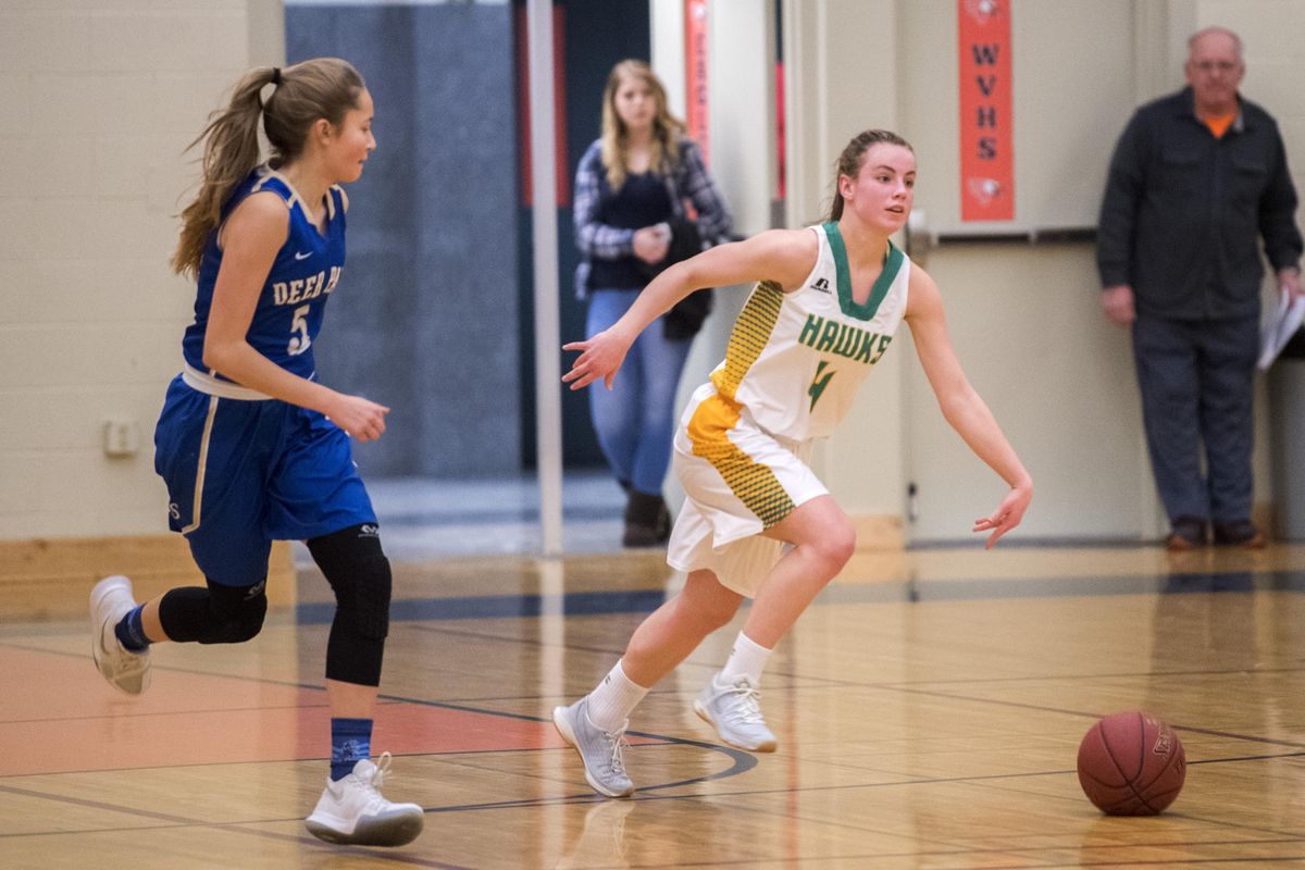 Lakeland  Hawks guard Lauryn Cooper, right, maneuvers around Deer Park’s Taylor Lyons, left, in the first game of the Eagle Holiday Classic, a basketball tournament for many small high schools around the region, Wednesday, Dec. 27, 2017, at West Valley High School. (Jesse Tinsley / The Spokesman-Review)