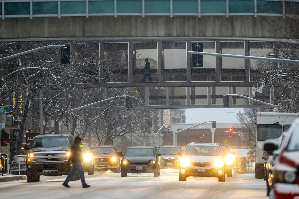 Pedestrians and commuters mix during a chilly evening Tuesday on West Main Avenue in downtown Spokane. A warming trend is coming, with high temperatures in the 40-degree range returning Friday.  (COLIN MULVANY/THE SPOKESMAN-REVI)