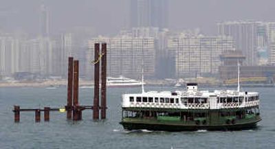 
A ferry sails past pilings  of a reclamation site in Hong Kong's Victoria Harbor, near the city's financial district. Associated Press
 (Associated Press / The Spokesman-Review)