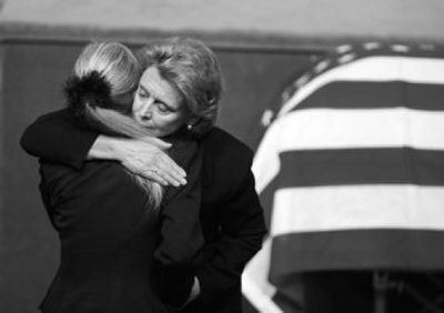 
Gov. Chris Gregoire, right, hugs Maria Cox, wife of slain  Deputy Steve Cox, during his funeral service in SeaTac on Friday. 
 (Associated Press / The Spokesman-Review)
