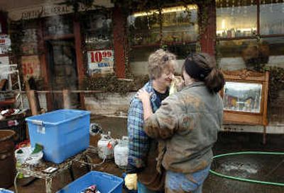 
As recovery from last week's record flood continues, Lacey Blair, right, wipes mud from the face of Curtis General Store owner Gloria Koidahl on Sunday in Curtis, Wash. The two were cleaning items taken from Koidahl's home. The Chronicle
 (Mike Salsbury The Chronicle / The Spokesman-Review)
