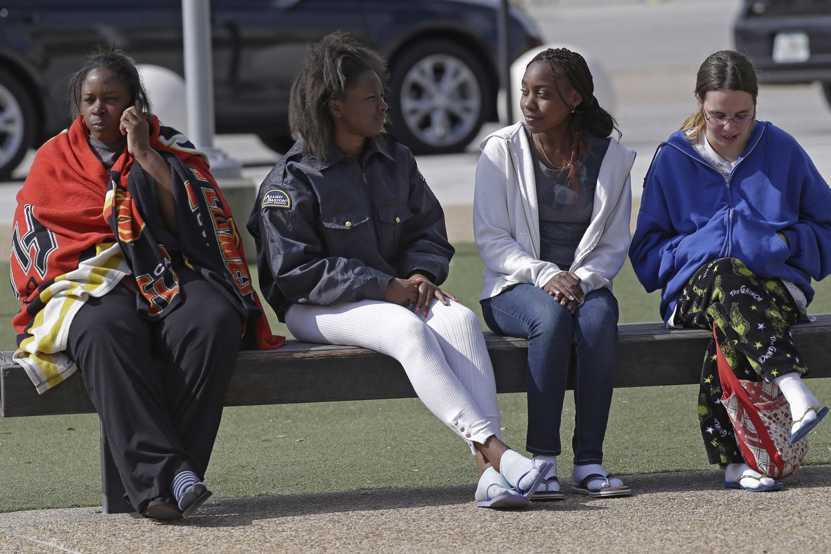 University of Central Florida students wait outside the college sports arena Monday after they were evacuated from their dorm when explosive devices were found. (Associated Press)