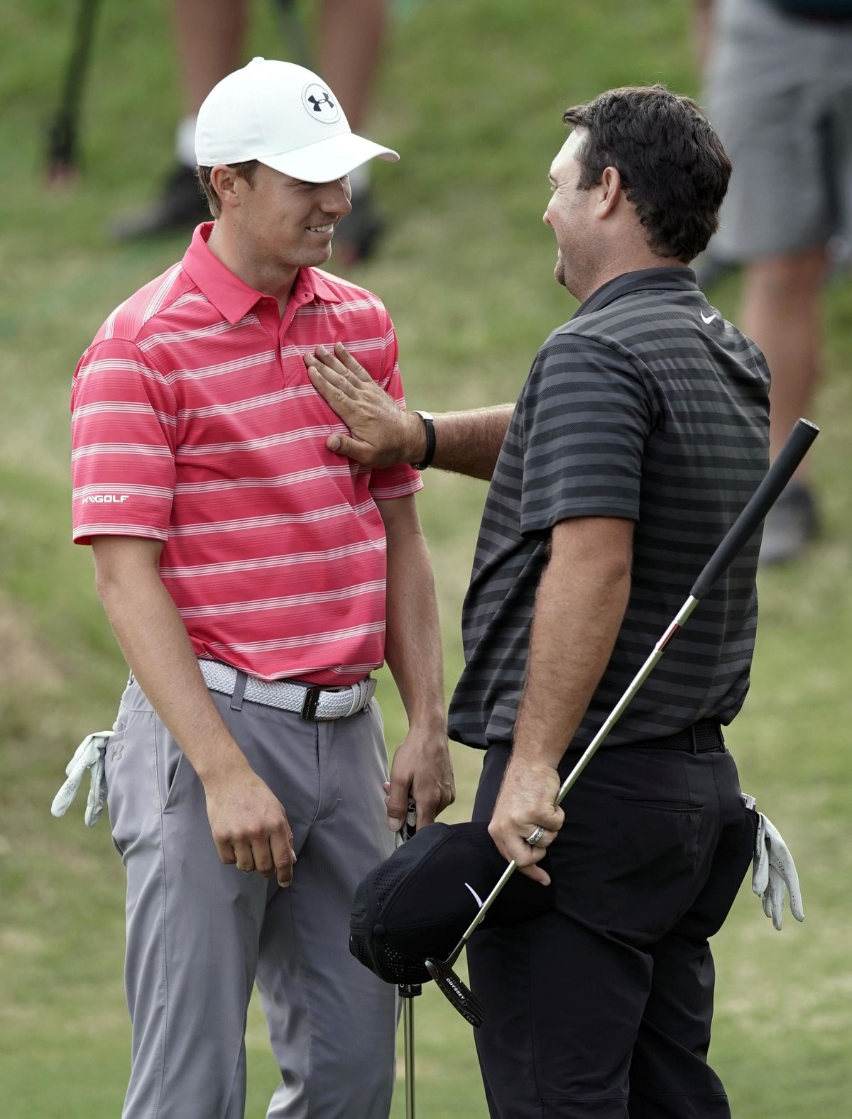 Jordan Spieth, left, is patted on the chest by opponent Patrick Reed, right, after losing the round in round-robin play at the Dell Technologies Match Play golf tournament, Friday, March 23, 2018, in Austin, Texas. (Eric Gay / Associated Press)