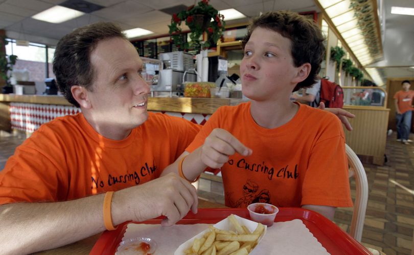 ORG XMIT: LA109  ** FILE ** In this Wednesday March 5, 2008 file photo, McKay Hatch, right, the founder of the 50-member South Pasadena High School's No Cussing Club, jokes with his father, Brent Hatch, at his father's restaurant , in South Pasadena, Calif. McKay Hatch, whose stand against public profanity has suddenly subjected him to a torrent of four-letter-word abuse and other harassment. He and his family did draw the line, however, when the death threats started coming in over the Internet. They contacted the local police department, which confirmed Wednesday Jan. 14, 2009, that it is investigating. (AP Photo/Nick Ut, File) (Nick Ut / The Spokesman-Review)