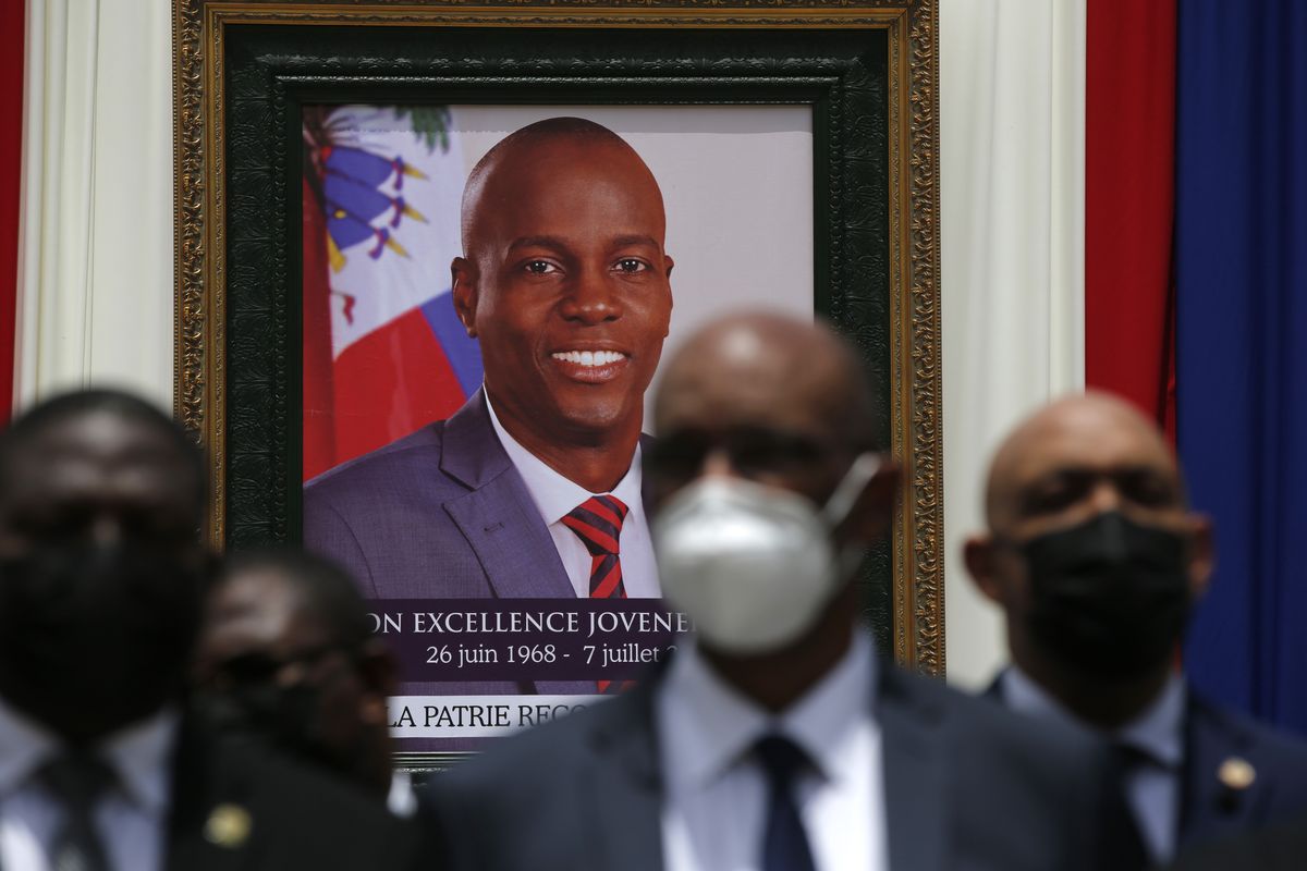 FILE - In this July 20, 2021 file photo, authorities pose for a group photo in front of the portrait of late Haitian President Jovenel Moise at at the National Pantheon Museum during his memorial service in Port-au-Prince, Haiti. Moise was assassinated on July 7 at his home.  (Joseph Odelyn)