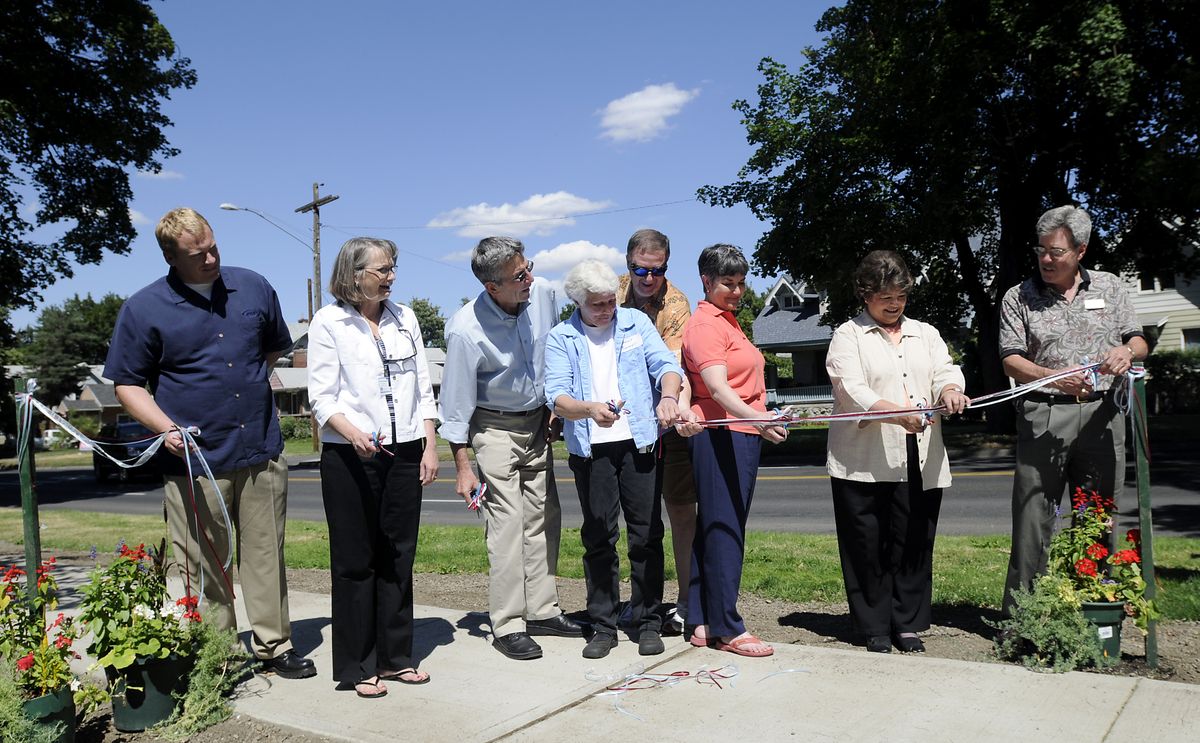 City of Spokane and Cancer Patient Care officials cut the ribbon to dedicate the Walk of Hope along Manito Park and Grand Boulevard on  Saturday.   (Jesse Tinsley / The Spokesman-Review)