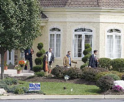 
A team of FBI agents leaves a house in Springfield, Pa., reportedly owned by Charlie Sexton, an associate of Rep. Curt Weldon, R-Pa., on Monday. The FBI raided the homes of Weldon's daughter and Sexton as it investigates whether the congressman improperly helped the pair win lobbying and consulting contracts. 
 (Associated Press / The Spokesman-Review)