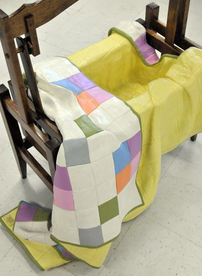 Tim Rahman carved a cradle and quilt out of solid wood.