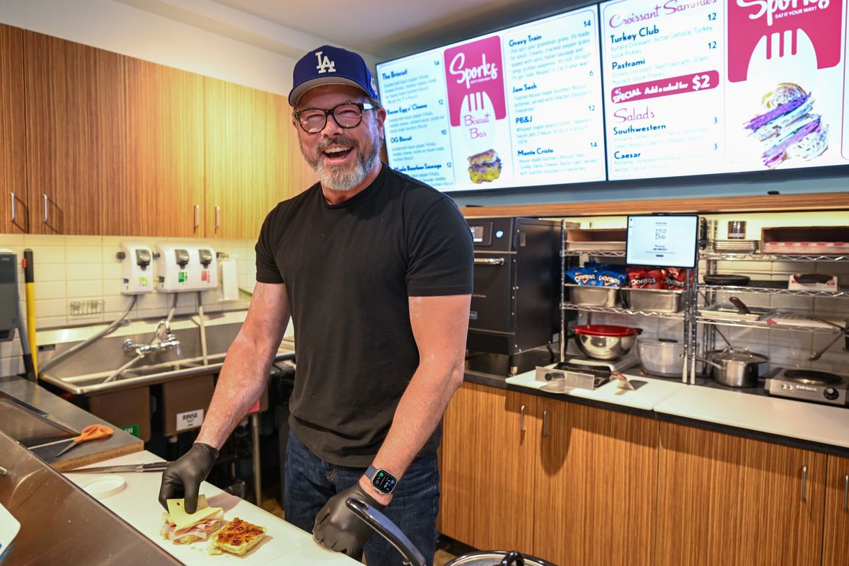 Owner Doyle Wheeler laughs as he assembles the Monte Cristo biscuit on Thursday at Sporks Biscuit Bar in downtown Spokane. Spork’s took over the second-floor location previously occupied by the High Tide Lobster Bar above Numerica Credit Union at Riverside Avenue and Stevens Street. The small snack bar is an extension of Wheeler’s other business, First Avenue Coffee.  (Jesse Tinsley/THE SPOKESMAN-REVIEW)