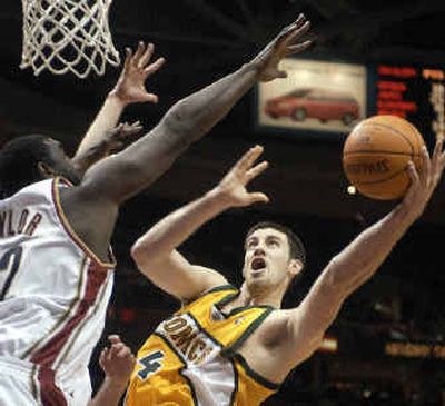 
 Supersonics' Nick Collison, right, tries to maneuver around Cavaliers' Robert Traylor to the basket. 
 (Associated Press / The Spokesman-Review)