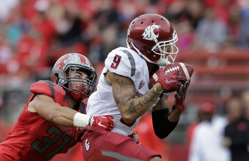 Washington State wide receiver Gabe Marks collects a first-half pass against the watchful eye of Rutgers defensive back Anthony Cioffi during Saturday’s game. (Associated Press)