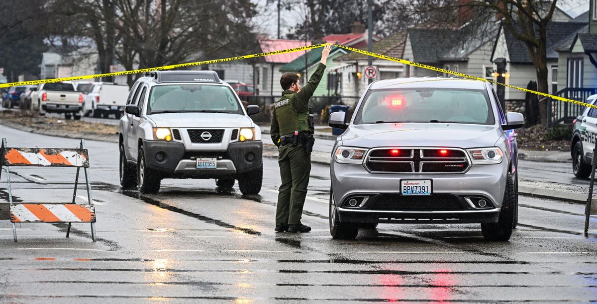 Law enforcement leaves the scene of a police shooting near the corner of Nevada Street and Wellesley Avenue Monday morning in Spokane.  (DAN PELLE/THE SPOKESMAN-REVIEW)